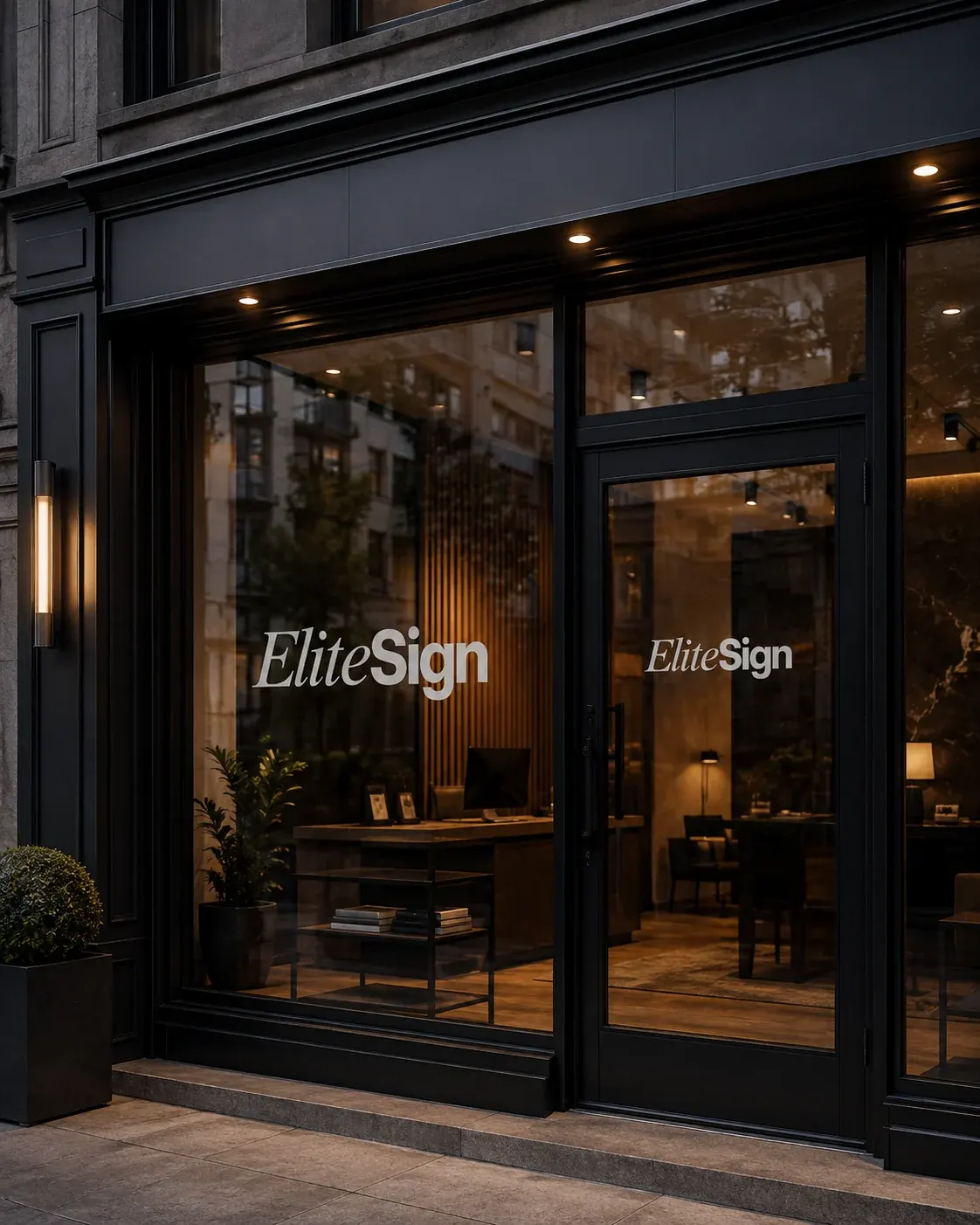 Hvidt Elite Sign vinyl-logo på glasfacade